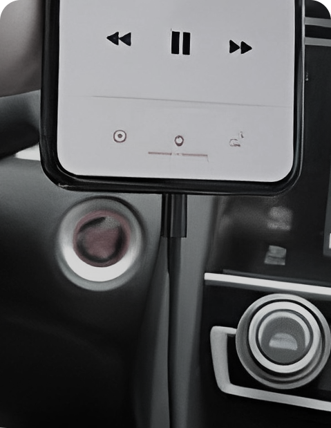 Smartphone connected via USB cable in car showing music playback, highlighting need for Ottocast wireless CarPlay adapter